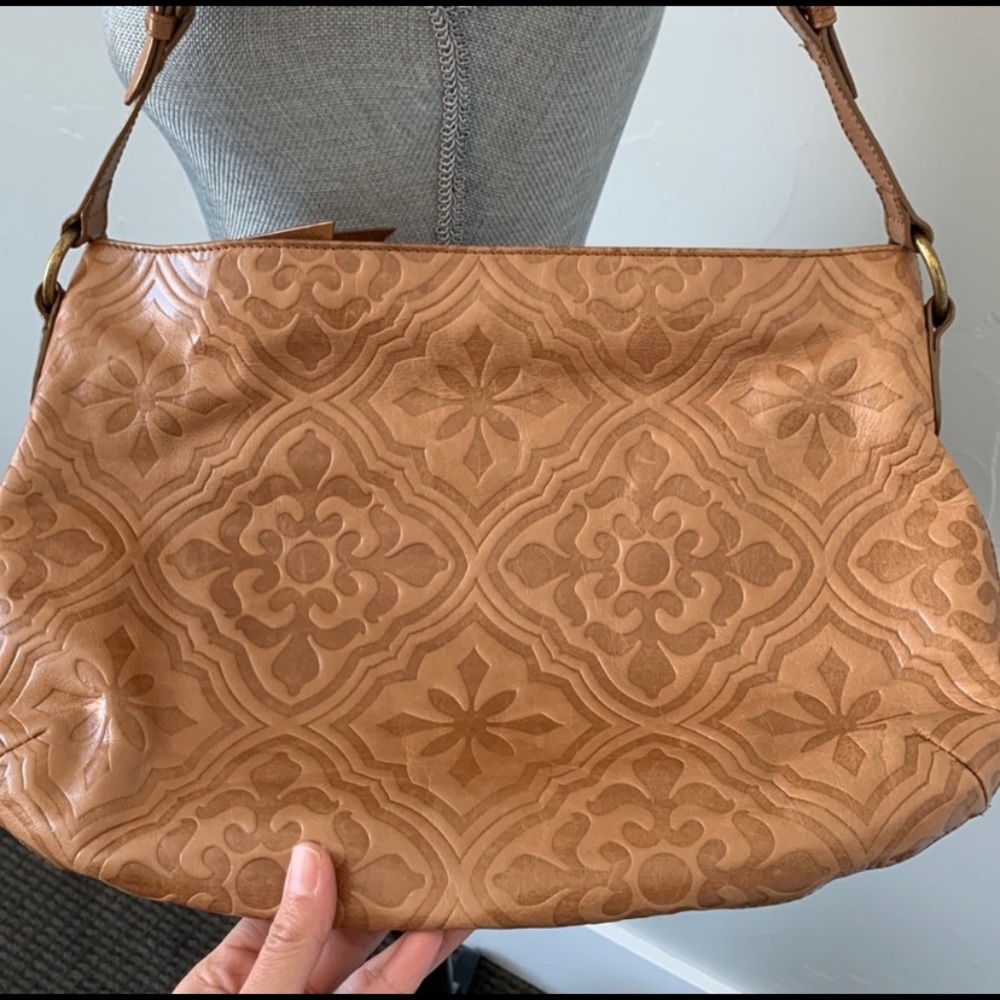 Boho style tan embossed leather Hobo brand shoulder bag.
